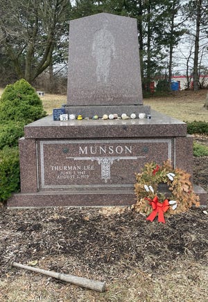 A baseball bat, hand-delivered from a Thurman Munson fan in New Jersey in 2021, still lies at Munson's gravesite.